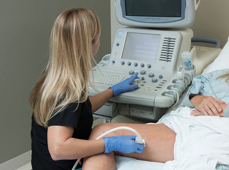 Doctor from Central Florida Vein and Vascular Center performing diagnostic vascular ultrasound for abnormal leg veins
