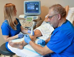 Doctors at CF Vein's The Villages location performing a Ultrasound-Guided Foam Sclerotherapy for painful leg veins.