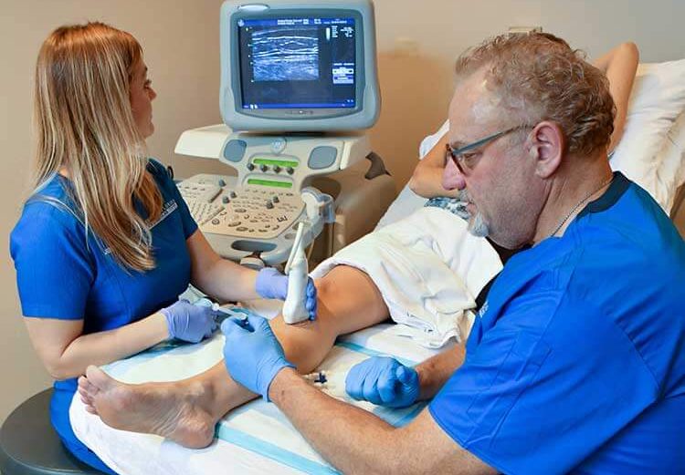 Doctors at CF Vein's The Villages location performing a Ultrasound-Guided Foam Sclerotherapy for painful leg veins.