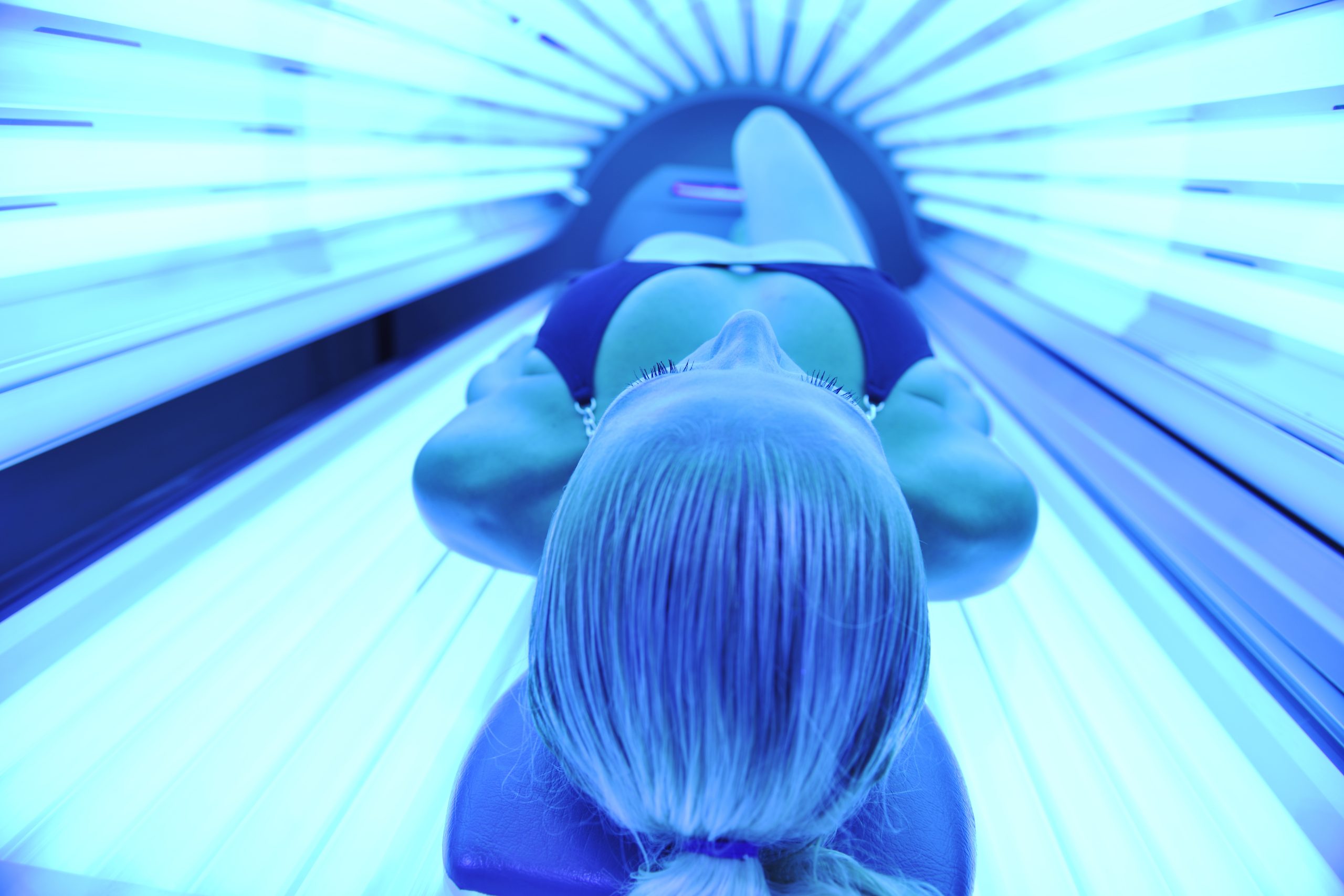 Woman in tanning bed